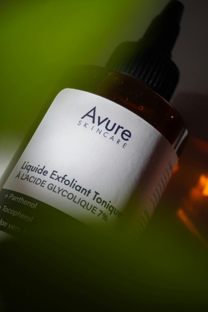 Close-up of Avure skincare glycolic acid exfoliating serum bottle with aloe vera.